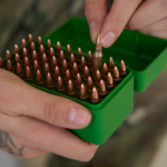Picking bullet from box.