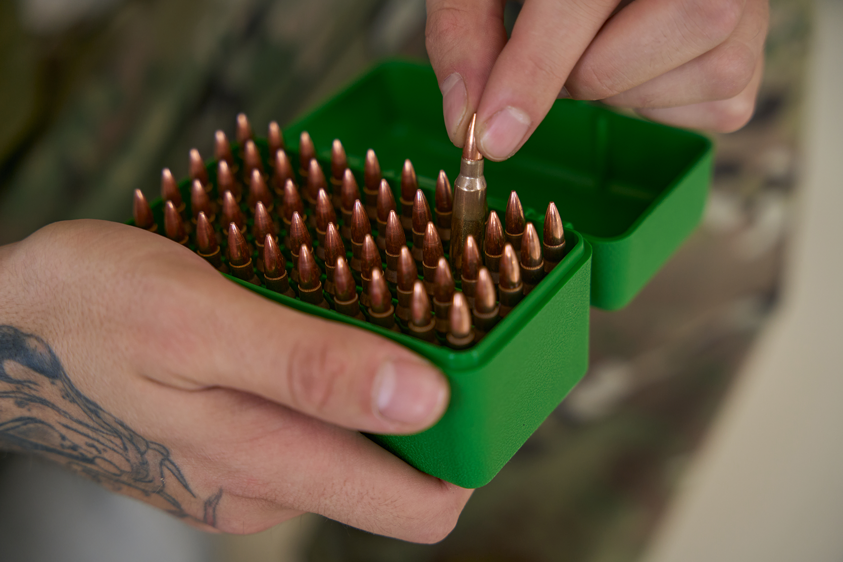 Picking bullet from box.